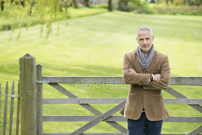Portrait of confident mature man standing in park — Stock Photo