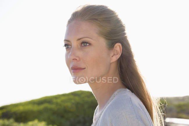Close-up of thoughtful elegant woman looking away outdoors — Stock Photo