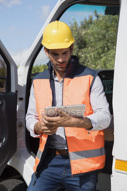 Ingénieur masculin utilisant une tablette numérique chez van — Photo de stock
