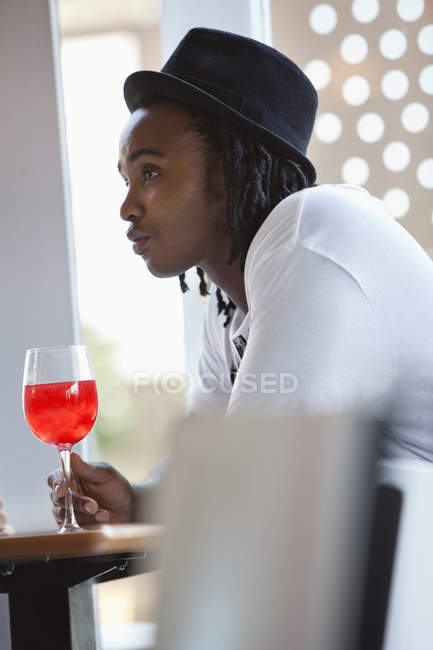 Young man having red wine at bar — Stock Photo