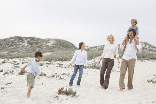 Familia disfrutando en la playa - foto de stock