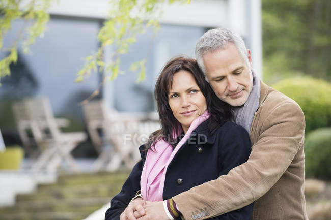 Romántica pareja pensativa sentada en el jardín - foto de stock