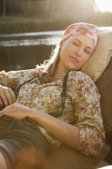 Portrait of relaxed woman resting in boat — Stock Photo