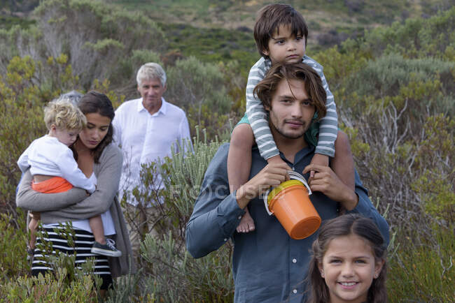 Happy multi-generation family walking on landscape — Stock Photo