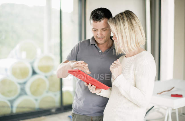 Couple using digital tablet at home — Stock Photo