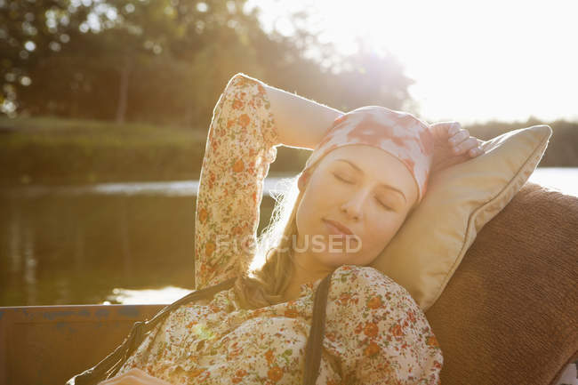 Portrait of relaxed woman resting in boat — Stock Photo