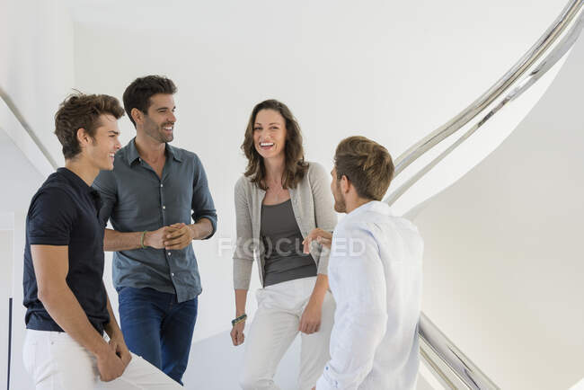 Happy business friends talking to each other — Stock Photo