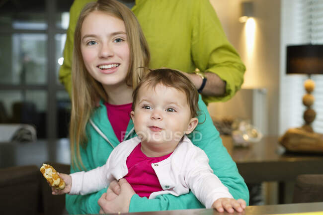 Portrait of two girls with their father at home — Stock Photo