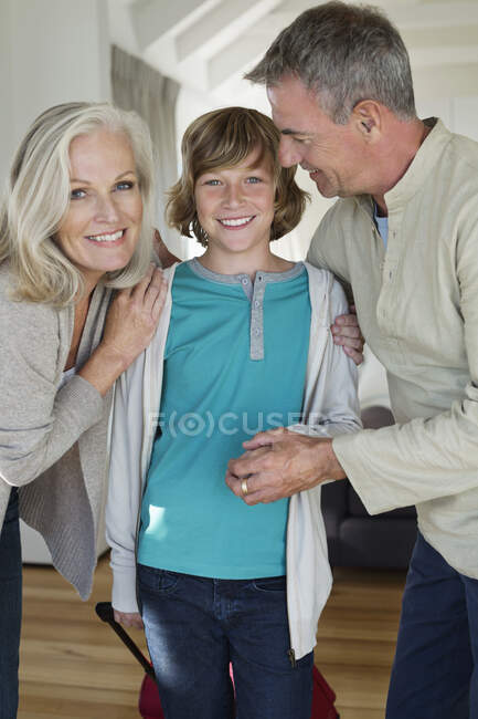 Portrait of a boy with his grandparents at home — Stock Photo