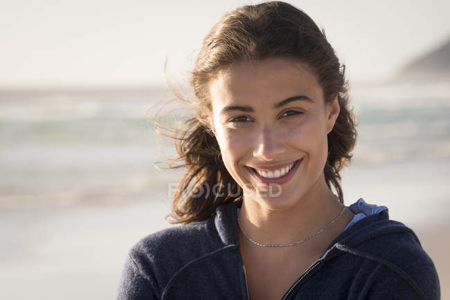 Portrait of happy young woman on beach — Stock Photo