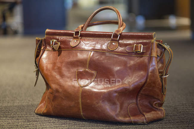 Primo piano della borsa in pelle in aeroporto, attenzione selettiva — Foto stock