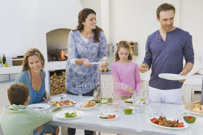 Family having breakfast at the dining table — Stock Photo