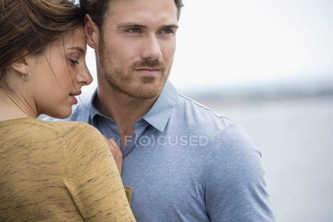 Close-up of romantic young couple embracing outdoors — Stock Photo