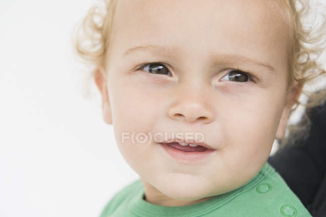 Close Up Of Cute Baby Boy Looking Away Blonde Hair Curly Hair