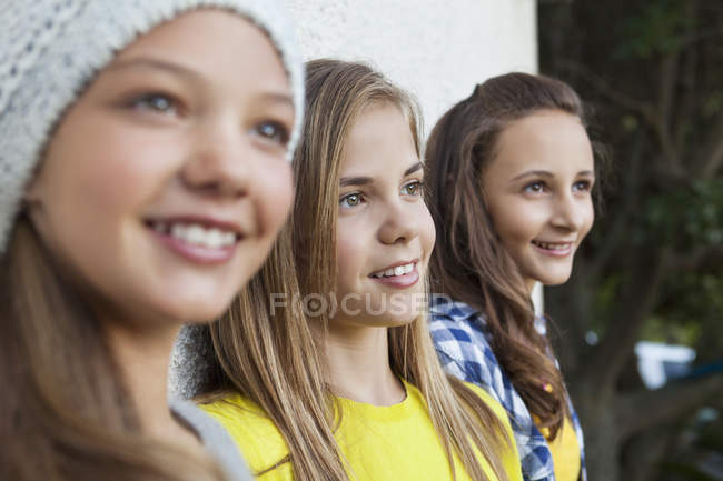 Close-up of three teenage girls staring outdoors — Stock Photo