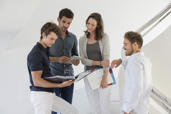 Happy colleagues discussing a file — Stock Photo