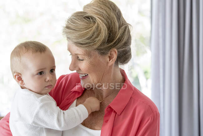 Happy grandmother with baby granddaughter — Stock Photo
