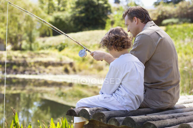Father and son fishing in a lake — Stock Photo