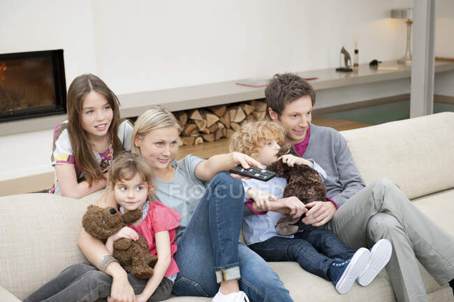 Família assistindo televisão em casa — Fotografia de Stock