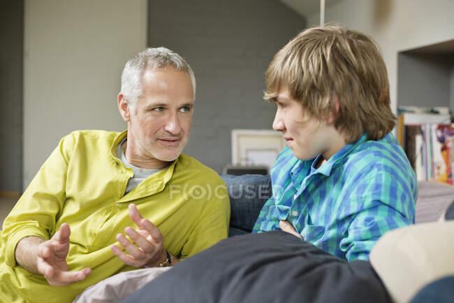 Man talking with his son at home — Stock Photo
