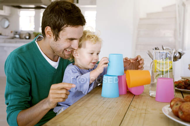 Father and son playing in kitchen — Stock Photo