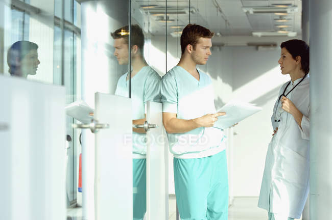 Doctors discussing medical record in clinic — Stock Photo