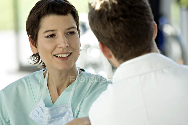 Close-up of female doctor discussing with male doctor in hospital — Stock Photo