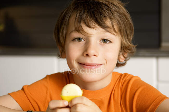 Portrait of a boy holding cheese — Stock Photo