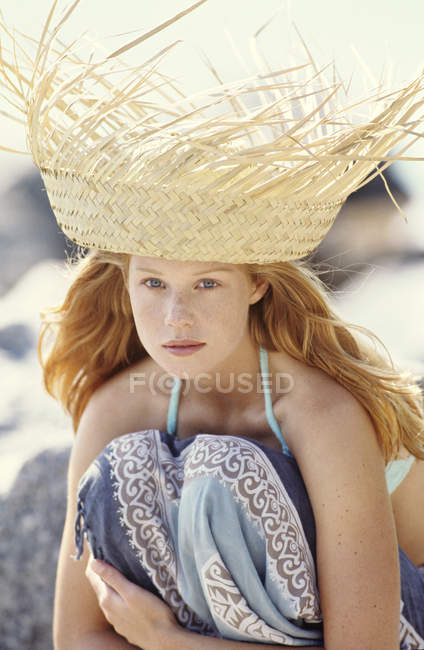 Portrait of young redheaded woman in stylish straw hat outdoors — Stock Photo