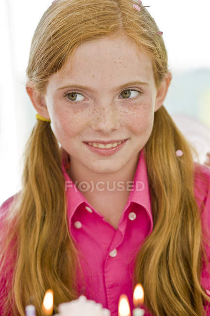 Close-up of ginger girl holding birthday cake — Stock Photo