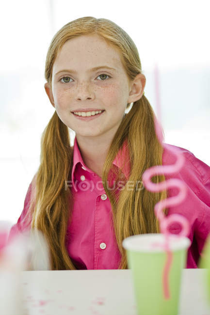 Portrait of smiling ginger girl at birthday party — Stock Photo