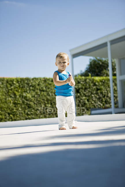 Portrait of baby boy holding toy car outdoors — Stock Photo