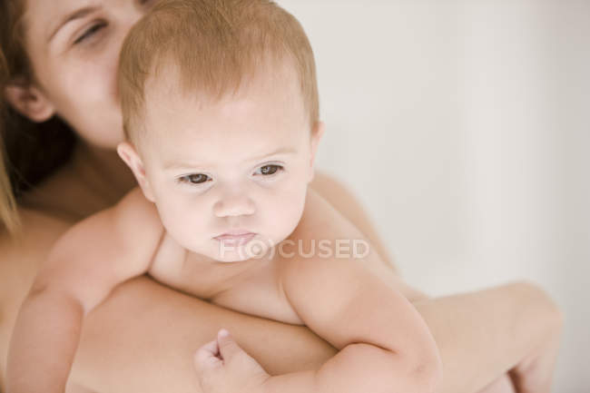 Close-up of happy woman carrying baby daughter — Stock Photo