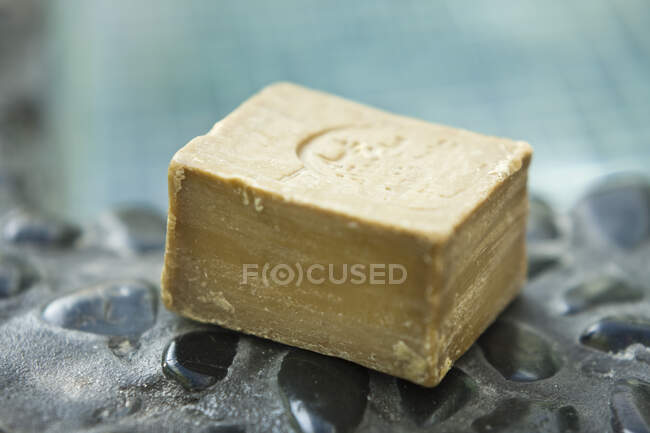 Close-up of a bar of soap on a poolside — Stock Photo