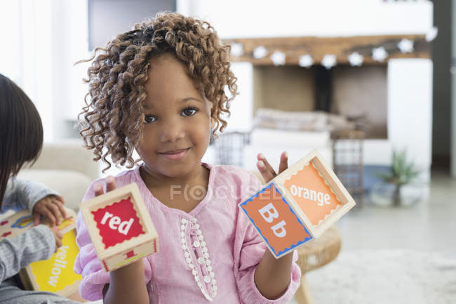 Portrait of little girl showing number blocks — Stock Photo
