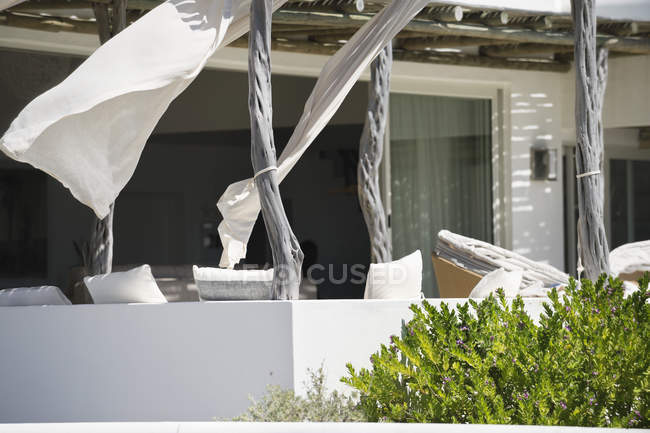 Porch of modern house with curtains in wind — Stock Photo