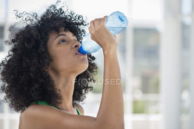 Close-up of woman drinking water from bottle — Stock Photo