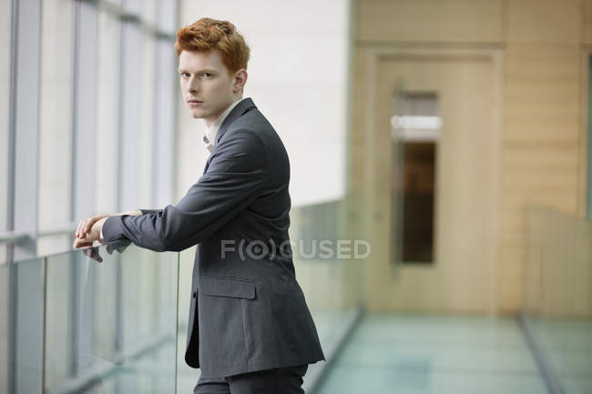 Портрет молодого бизнесмена, смотрящего в коридор — стоковое фото
