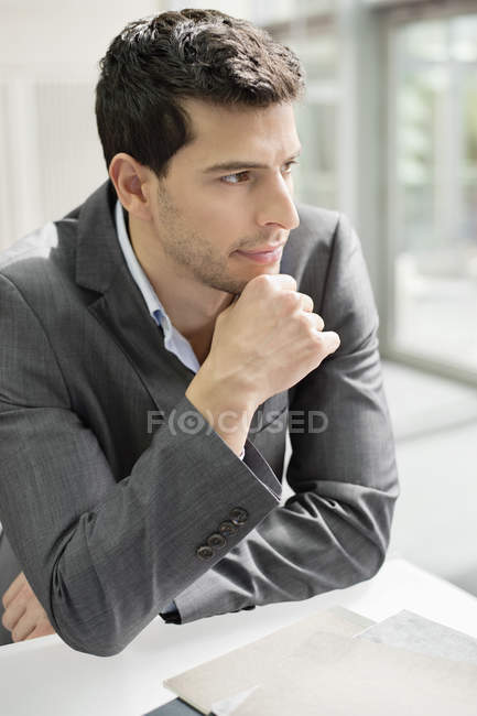 Close-up of confident businessman thinking in office — Stock Photo