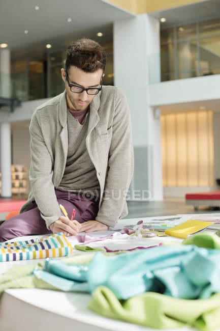 Portrait of male fashion designer working in office — Stock Photo