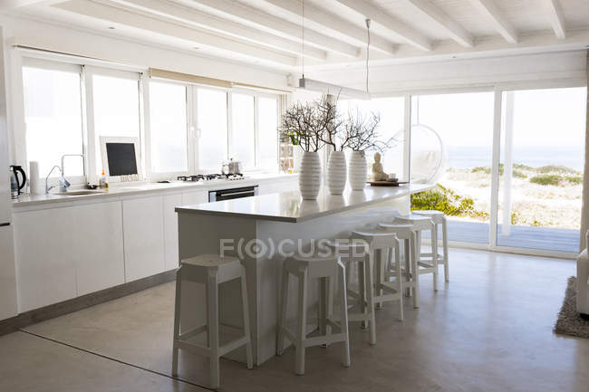 Interior of stylish light kitchen area in studio apartment of coastal house — Stock Photo
