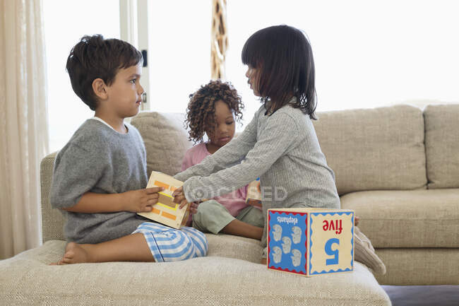 Children playing with number blocks — Stock Photo