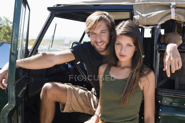 Portrait of a couple on SUV — Stock Photo