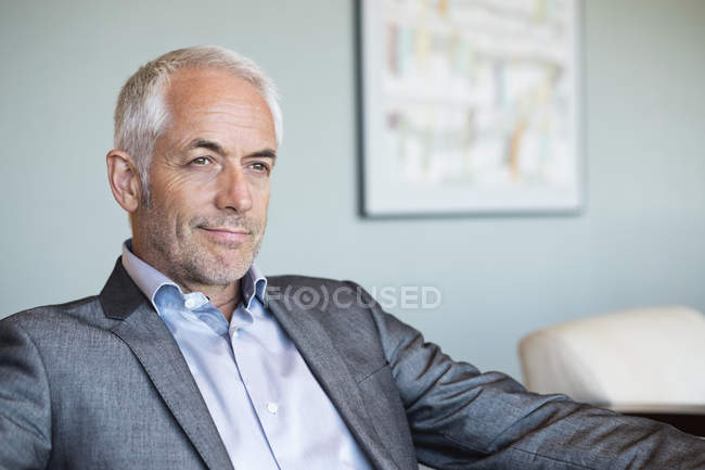Close-up of confident businessman thinking in office — Stock Photo