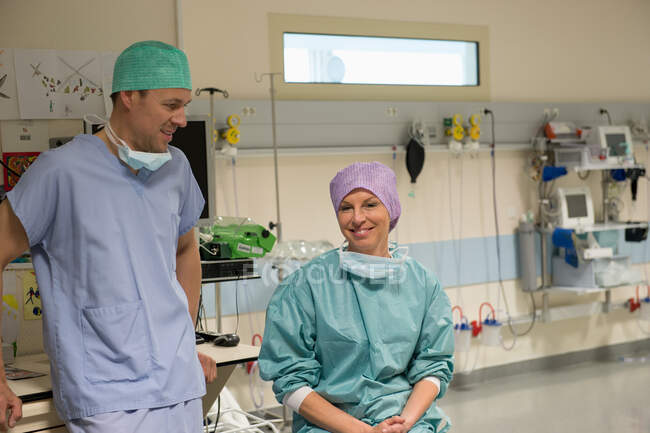 Cirujanos masculinos y femeninos en sala de recuperación - foto de stock