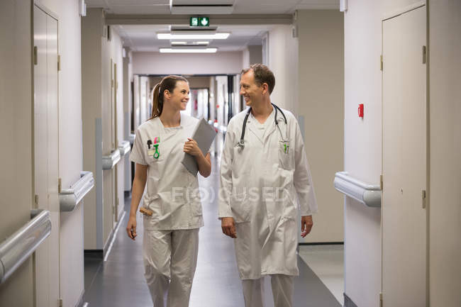 Medico e infermiera che camminano nel corridoio di un ospedale — Foto stock