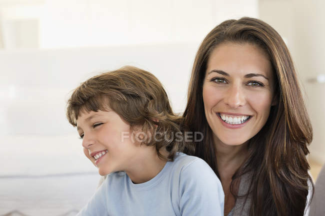 Portrait of woman and son smiling together — Stock Photo