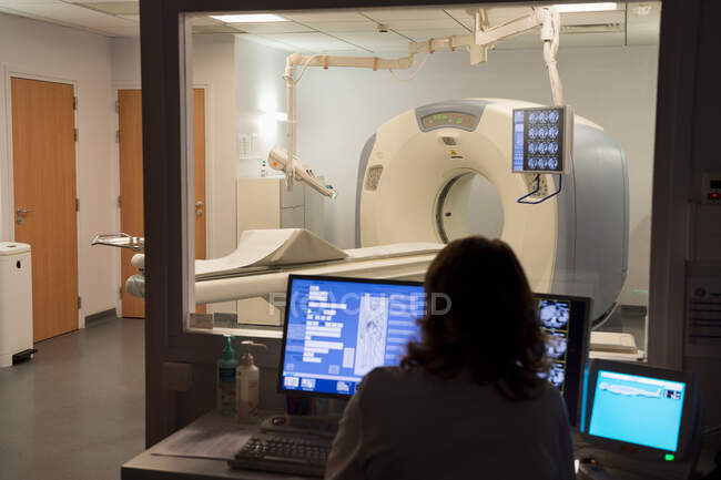 Medical practitioner examining MRI scan in monitor room — Stock Photo