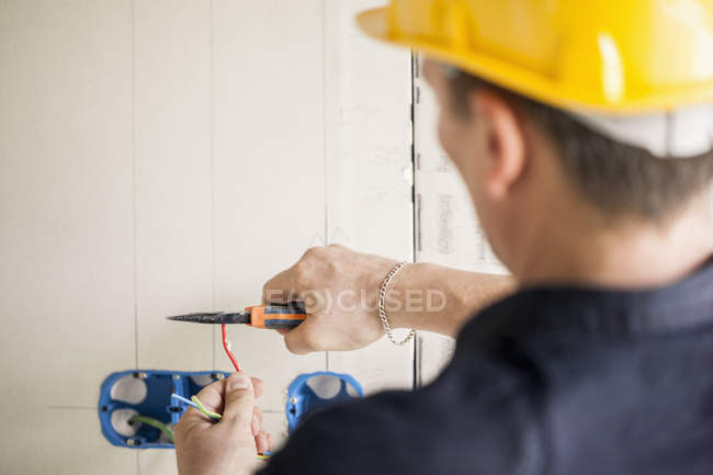 Male engineer in yellow helmet working at site — Stock Photo