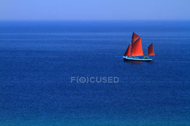 France, Brittany, old ship with red sails on blue sea. — Stock Photo